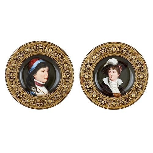Two Austrian circular painted porcelain plaques in brass frames