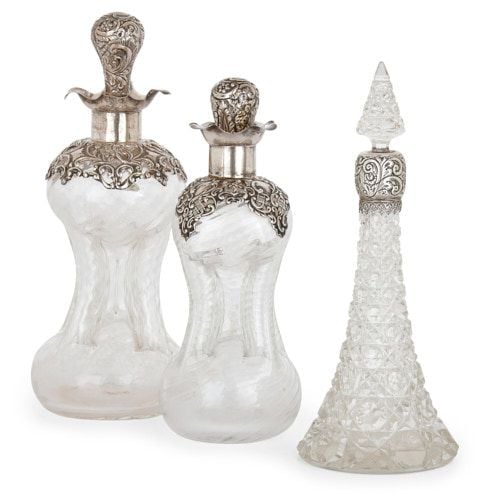 Set of three silver mounted glass perfume bottles