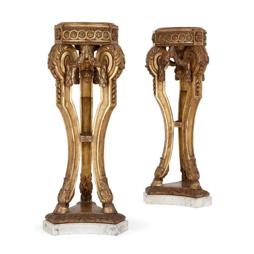 Pair of marble and carved giltwood antique tripod pedestals