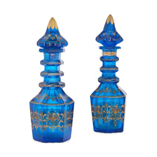 Two parcel gilt and royal blue glass antique decanters