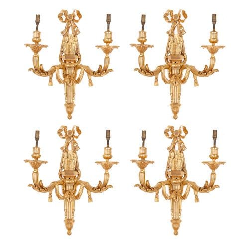 Set of four Louis XVI style ormolu twin light wall lights