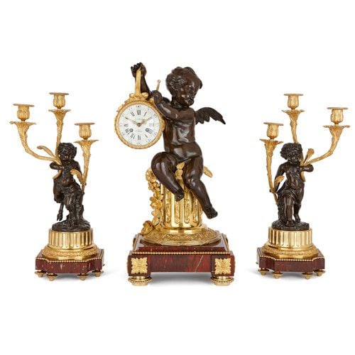 Marble, gilt and patinated bronze clock set with putti