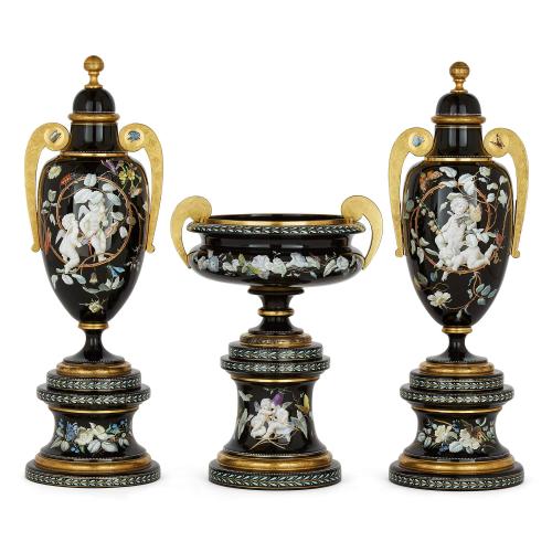 A three-piece Bohemian enamelled black glass vase garniture