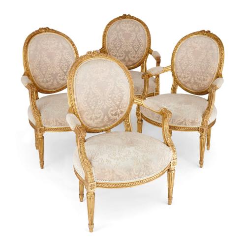 A suite of four Louis XVI style giltwood fauteuils 