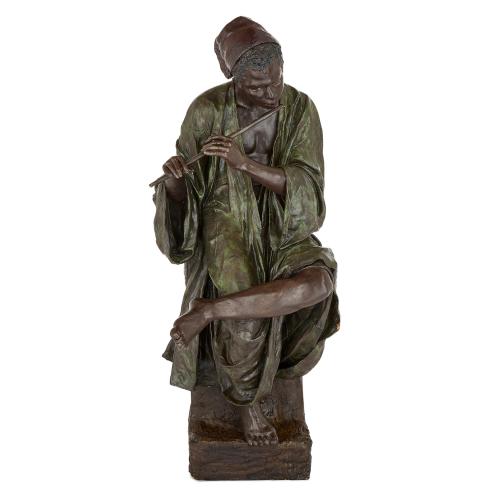 Large Goldscheider terracotta figure of a boy playing the flute