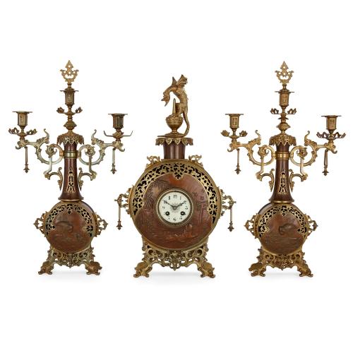 A French Japonisme ormolu and brass three-piece clock set