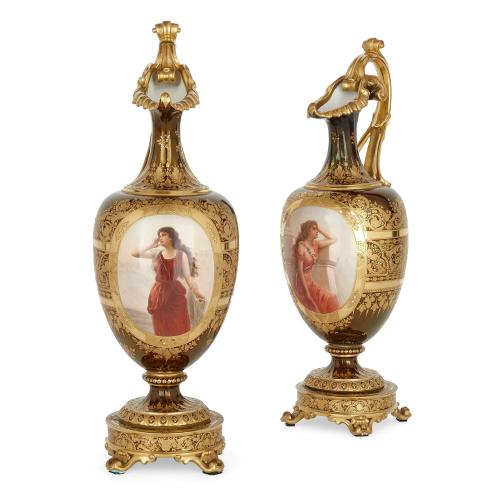 A pair of large Royal Vienna gilt painted porcelain ewers