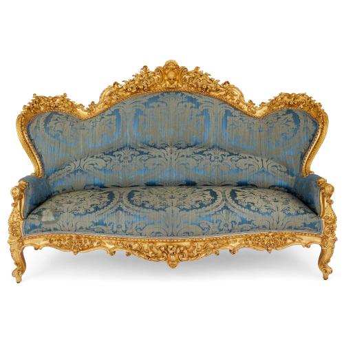 Large and very fine French Rococo revival carved giltwood sofa