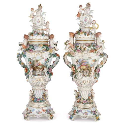 Pair of Rococo style Dresden porcelain vases with covers and bases