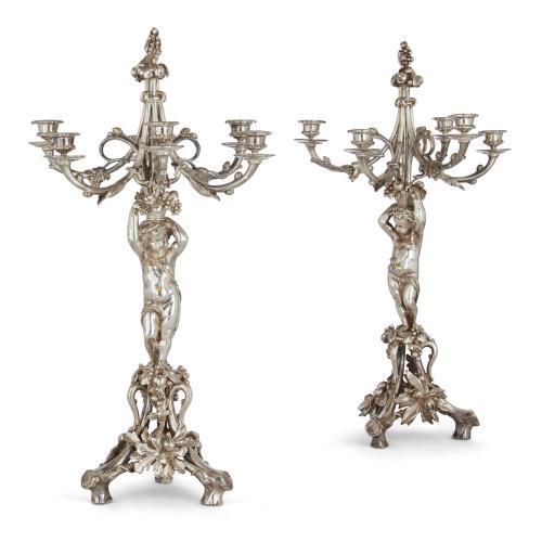 Pair of antique silvered bronze six-light candelabra with putti