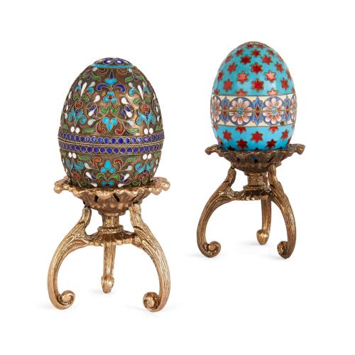 Two silver gilt and cloisonné enamel Russian Easter eggs on stands