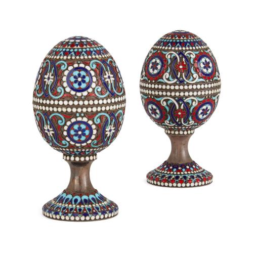 Two Russian silver gilt and cloisonné enamel eggs on stands