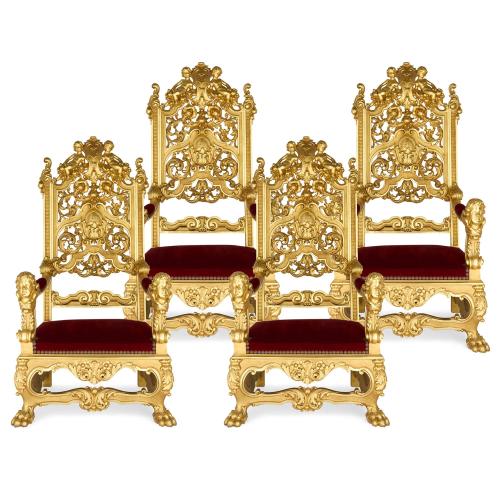 Set of four Italian Baroque style carved giltwood throne armchairs