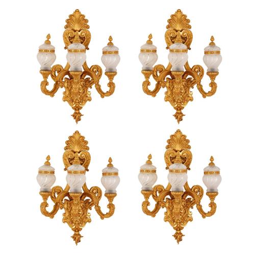 Set of four ormolu and glass three-light wall lights