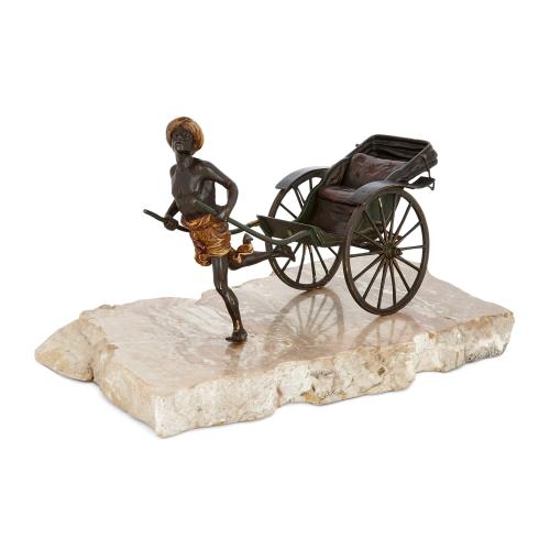 Cold-painted bronze sculpture of a pulled rickshaw by Bergman