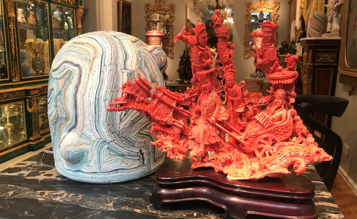 Chinese hand-carved coral displayed with Alice Walton's porcelain Mori Mandi sculpture