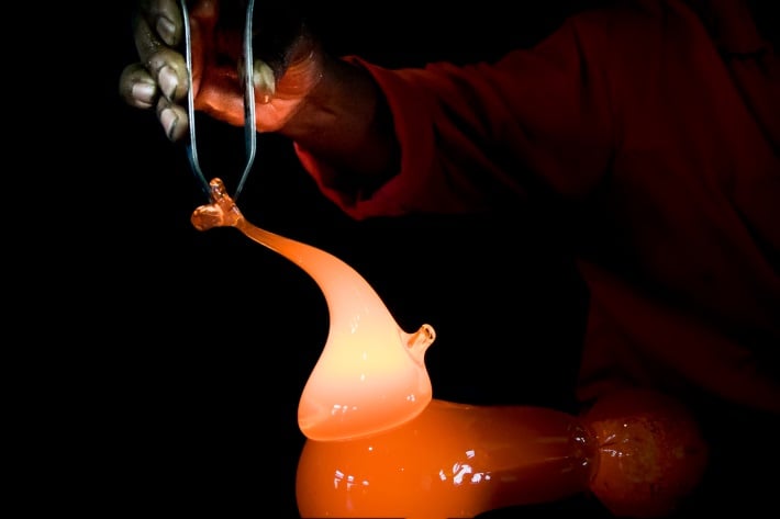 Craftsman working with molten glass